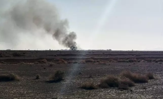 In this image provided by Sepahnews, the Iranian Revolutionary Guard's official website, black smoke rises into the air at what Iran's state TV claimed was the site where an American transport plane and two helicopters involved in a rescue operation were shot down, in Isfahan province, Iran, April, 2026. (Sepahnews via AP)