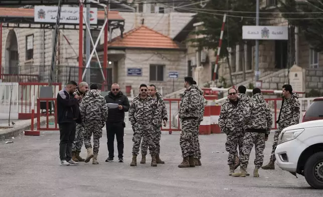 Members of Lebanon's General Security stand at the Masnaa border crossing in the Bekaa valley, eastern Lebanon, Sunday, April 5, 2026. (AP Photo/Bilal Hussein)