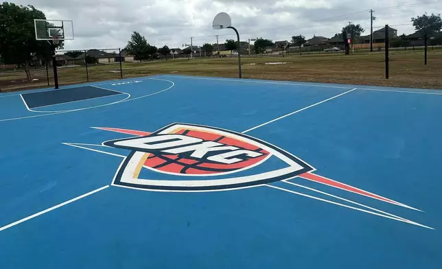The outdoor basketball court at Briarwood Elementary School, destroyed in a tornado in 2013, is a sign of the connection between the the NBA basketball team Oklahoma City Thunder and the greater Oklahoma City community, in shown, April 15, 2026, in Oklahoma City. Thunder dedicated the court in 2014 and resurfaced it in 2024. (AP Photo/Cliff Brunt)