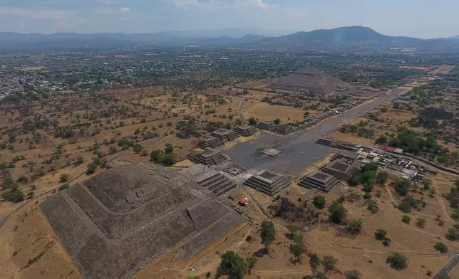 FILE - The Pyramid of the Moon, left, and the Pyramid of the Sun, back right, are seen along with smaller structures lining the Avenue of the Dead, in Teotihuacan, Mexico, March 19, 2020. (AP Photo/Rebecca Blackwell, File)