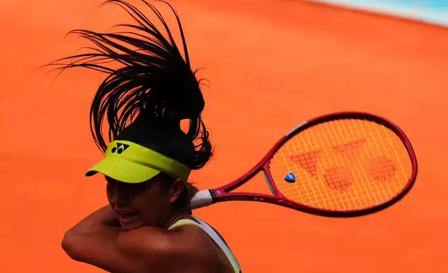Petra Marcinko of Croatia returns the ball to Belinda Bencic of Switzerland during the Madrid Open tennis tournament in Madrid, Spain, Thursday, April 23, 2026. (AP Photo/Manu Fernandez)