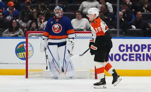 Philadelphia Flyers' Matvei Michkov (39) skates past New York Islanders goaltender Ilya Sorokin (30) after scoring a goal during the second period of an NHL hockey game Friday, April 3, 2026, in Elmont, N.Y. (AP Photo/Frank Franklin II)