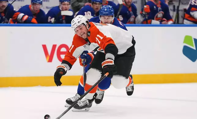 Philadelphia Flyers' Tyson Foerster (71) deke pastNew York Islanders' Adam Pelech (3) during the first period of an NHL hockey game Friday, April 3, 2026, in Elmont, N.Y. (AP Photo/Frank Franklin II)