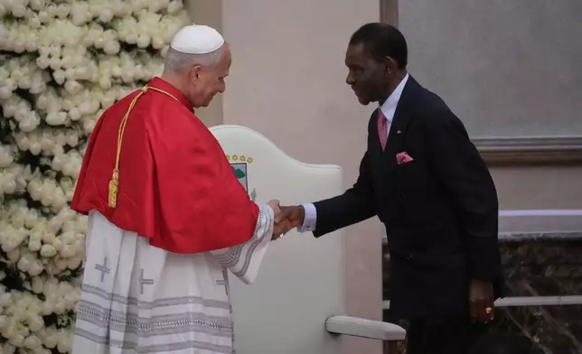 Pope Leo XIV shakes hands with Equatorial Guinea's President Teodoro Obiang Nguema Mbasogo as he meets with the authorities, civil society and the diplomatic corps in Malabo, Equatorial Guinea, Tuesday, April 21, 2026, on the ninth day of his 11-day pastoral visit to Africa. (AP Photo/Andrew Medichini)