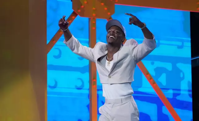 Ohio State wide receiver Carnell Tate celebrates after being chosen by the Tennessee Titans with the fourth overall pick during the first round of the NFL football draft, Thursday, April 23, 2026, in Pittsburgh. (AP Photo/Gene J. Puskar)