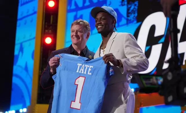 Ohio State wide receiver Carnell Tate poses with NFL Commissioner Roger Goodell after being chosen by the Tennessee Titans with the fourth overall pick during the first round of the NFL football draft, Thursday, April 23, 2026, in Pittsburgh. (AP Photo/Gene J. Puskar)