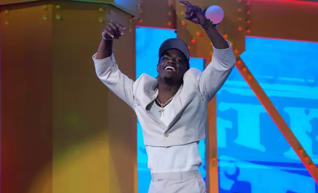 Ohio State wide receiver Carnell Tate celebrates after being chosen by the Tennessee Titans with the fourth overall pick during the first round of the NFL football draft, Thursday, April 23, 2026, in Pittsburgh. (AP Photo/Gene J. Puskar)