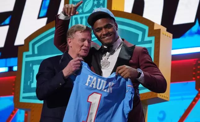Auburn defensive lineman Keldric Faulk poses with NFL Commissioner Roger Goodell after being chosen by the Tennessee Titans with the 31st overall pick during the first round of the NFL football draft, Thursday, April 23, 2026, in Pittsburgh. (AP Photo/Gene J. Puskar)