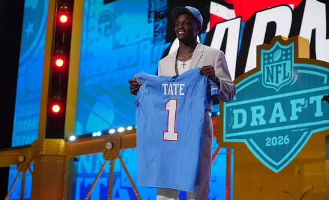 Ohio State wide receiver Carnell Tate poses after being chosen by the Tennessee Titans with the fourth overall pick during the first round of the NFL football draft, Thursday, April 23, 2026, in Pittsburgh. (AP Photo/Gene J. Puskar)