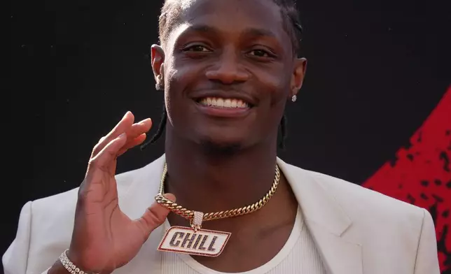 Ohio State wide receiver Carnell Tate poses on the red carpet before the first round of the NFL football draft, Thursday, April 23, 2026, in Pittsburgh. (AP Photo/Gene J. Puskar)