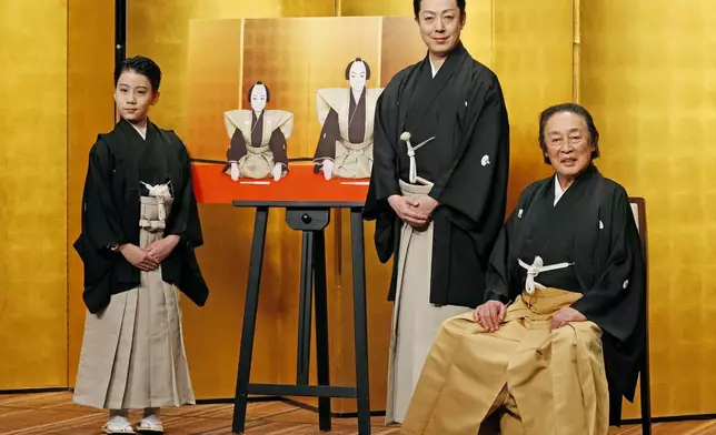 Kabuki actors, from right to left, the seventh Kikugoro Onoe, his son Kikunosuke Onoe and his grandson, Ushinosuke Onoe pose for a photo after a press conference in Tokyo, on May 27, 2024. (Kyodo News via AP)