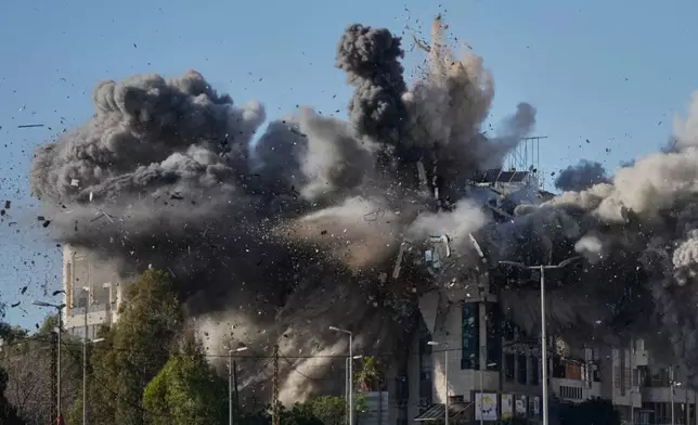 Smoke rises after an Israeli airstrike hits a building near the airport road in Beirut, Lebanon, Tuesday, March 31, 2026. (AP Photo/Hussein Malla)