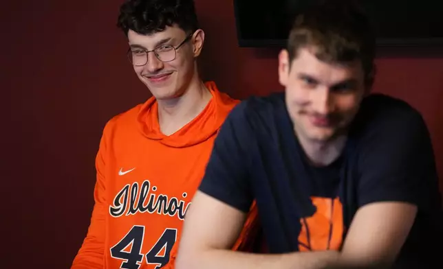Illinois center Zvonimir Ivisic, left, listens as brother and teammate Tomislav Ivisic, right, answer questions during a news conference for the Elite Eight of the NCAA college basketball tournament, Friday, March 27, 2026, in Austin, Texas. (AP Photo/Eric Gay)