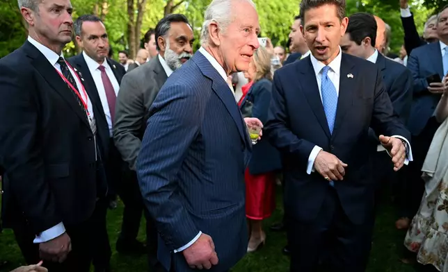 Britain's King Charles III speaks with Christian Turner, British ambassador to the United States, during a garden party at the British Embassy, Monday, April 27, 2026, in Washington. (Roberto Schmidt/Pool via AP)