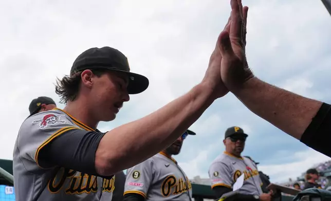 Pittsburgh Pirates starting pitcher Bubba Chandler, left, celebrates with a teammate in the dugout after first inning of a baseball game against the Chicago Cubs in Chicago, Sunday, April 12, 2026. (AP Photo/Nam Y. Huh)