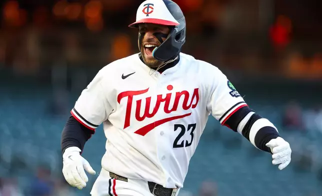 Minnesota Twins' Royce Lewis celebrates after hitting a single to score 2 runs batted in during the first inning of a baseball game against the Detroit Tigers Wednesday, April 8, 2026, in Minneapolis. (AP Photo/Ellen Schmidt)