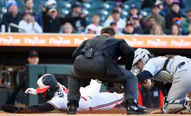 Minnesota Twins' Luke Keaschall, left, slides safely into home plate while Detroit Tigers catcher Dillon Dingler, right, attempts to tag him out during the first inning of a baseball game Wednesday, April 8, 2026, in Minneapolis. (AP Photo/Ellen Schmidt)