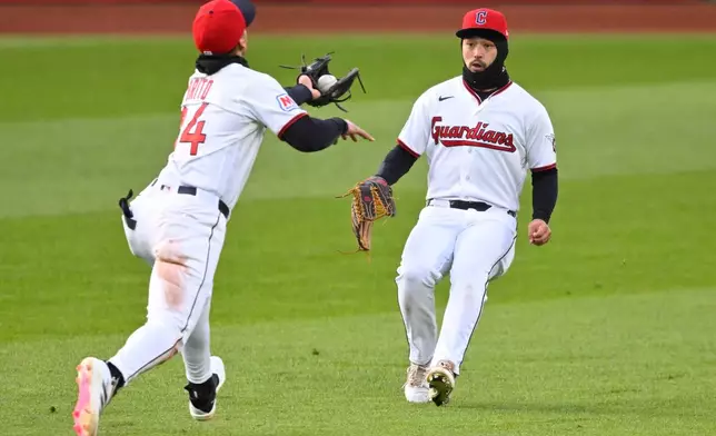 Cleveland Guardians second baseman Juan Brito, left, catches a fly ball in front of center fielder Steven Kwan, right, in the fourth inning of a baseball game against the Houston Astros in Cleveland, Monday, April 20, 2026. (AP Photo/David Richard)
