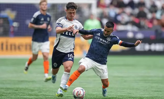 Vancouver Whitecaps' Sebastian Berhalter (16) and New York City FC's Maximiliano Moralez, right, vie for the ball during the first half of an MLS soccer match in Vancouver, British Columbia, Saturday, April 11, 2026. (Darryl Dyck/The Canadian Press via AP)