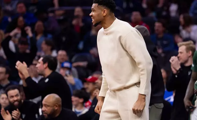 Milwaukee Bucks power forward Giannis Antetokounmpo, center, reacts from the sideline during the first half of an NBA basketball game against the Philadelphia 76ers, Sunday, April 12, 2026, in Philadelphia. (AP Photo/Chris Szagola)