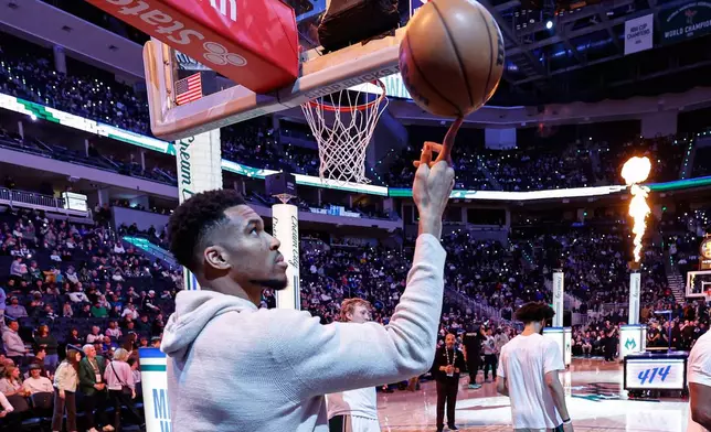 Milwaukee Bucks forward Giannis Antetokounmpo (34) spins the ball on his finger before an NBA basketball game against the Brooklyn Nets Friday, April 10, 2026, in Milwaukee. (AP Photo/Jeffrey Phelps)