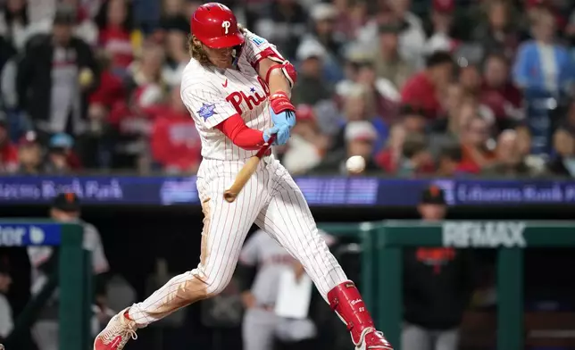 Philadelphia Phillies' Alec Bohm hits a run-scoring double against San Francisco Giants pitcher Matt Gage during the sixth inning of a baseball game Tuesday, April 28, 2026, in Philadelphia. (AP Photo/Matt Slocum)