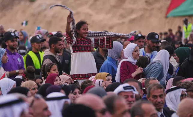 Palestinians watch and celebrate a mass wedding ceremony in Deir al-Balah, central Gaza Strip, Friday, April 24, 2026. (AP Photo/Abdel Kareem Hana)