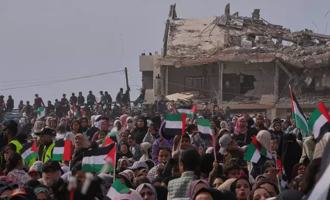 Palestinians watch and celebrate a mass wedding ceremony in Deir al-Balah, central Gaza Strip, Friday, April 24, 2026. (AP Photo/Abdel Kareem Hana)