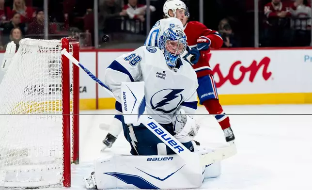 Tampa Bay Lightning goaltender Andrei Vasilevskiy (88) makes a save during first-period NHL hockey game action against the Montreal Canadiens in Montreal, Thursday, April 9, 2026. (Christopher Katsarov/The Canadian Press via AP)
