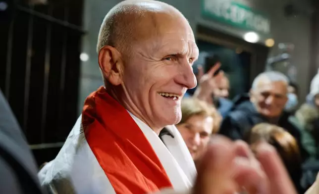 FILE - Nobel Peace Prize laureate Ales Bialiatski, one of released Belarusian prisoners, smiles surrounded by his supporters as he arrives at the U.S. Embassy in Vilnius, Lithuania, on Saturday, Dec. 13, 2025. (AP Photo/Mindaugas Kulbis, File)
