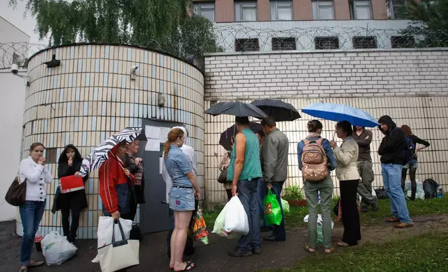 FILE - Relatives and friends of arrested participants of the flash mob "Revolution through a social network" wait outside the prison walls to bring food and clothes near a detention centre in Minsk, Belarus, Thursday, July 7, 2011. (AP Photo, File)