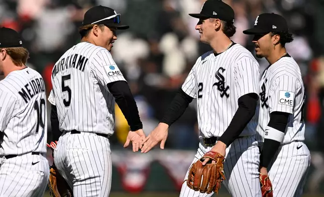 Chicago White Sox's Munetaka Murakami (5) celebrates with teammate Colson Montgomery, center right, after defeating the Toronto Blue Jays in a baseball game in Chicago, Sunday, April 5, 2026. (AP Photo/Paul Beaty)
