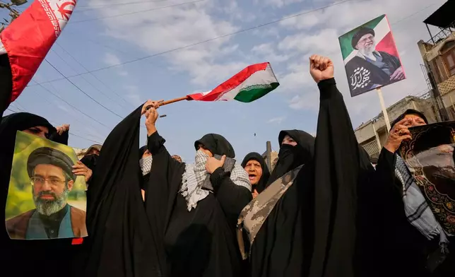 Iraqi Muslim women hold portraits of Iran's late Supreme Leader Ayatollah Ali Khamenei and his son Ayatollah Mojtaba Khamenei, during a protest against U.S. and Israeli attacks on multiple cities across Iran, in Baghdad, Iraq, Saturday, April 25, 2026. (AP Photo/Hadi Mizban)