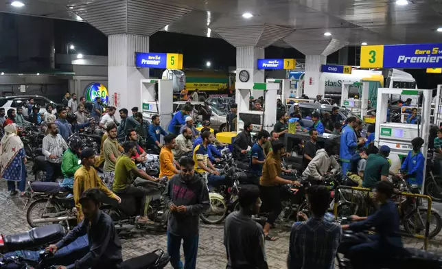 Motorcyclists crowd into a filling station as they wait their turn to buy fuel, in Karachi, Pakistan, Thursday, April 2, 2026. (AP Photo/Ali Raza)