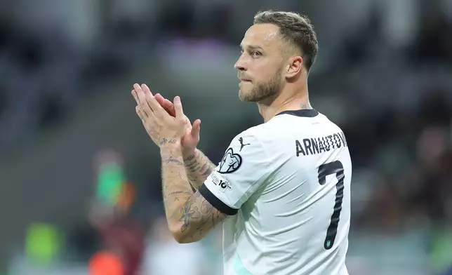 FILE - Austria's Marko Arnautovic applauds during the World Cup 2026 group H qualifying soccer match between Cyprus and Austria, in Limassol, Cyprus, Saturday, Nov. 15, 2025.(AP Photo/Chara Savvidou, File)