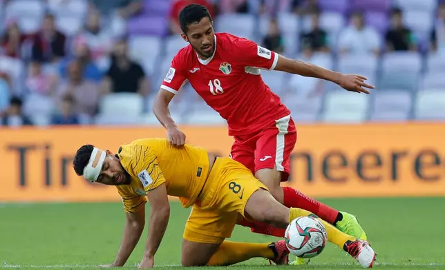 FILE - Jordan's midfielder Musa Al-Taamari, top, battles for a ball with Australia's midfielder Massimo Luongo during the AFC Asian Cup group B soccer match between Australia and Jordan at Hazza bin Zayed stadium in Al Ain, United Arab Emirates, Sunday, Jan. 6, 2019. (AP Photo/Hassan Ammar, File)