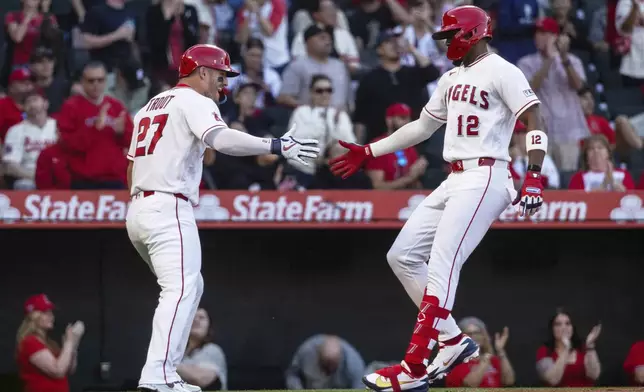 Los Angeles Angels' Mike Trout (27) celebrates with teammate Jorge Soler (12) after Soler's home run during the first inning of a baseball game against the Atlanta Braves, Tuesday, April 7, 2026, in Anaheim, Calif. (AP Photo/Ethan Swope)