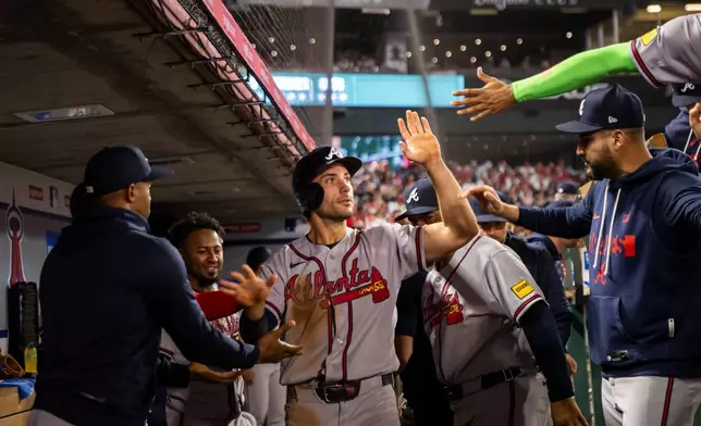 Atlanta Braves first baseman Matt Olson (28) celebrates after a run during the fourth inning of a baseball game against the Los Angeles Angels, Tuesday, April 7, 2026, in Anaheim, Calif. (AP Photo/Ethan Swope)