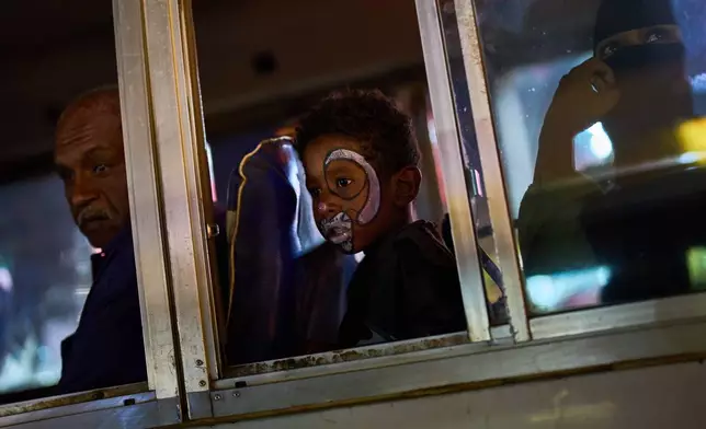 A child sits inside a bus, in Omdurman, Sudan, on the outskirts of Khartoum, Tuesday, April 21, 2026. (AP Photo/Bernat Armangue)