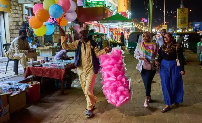 A street vendor sells candy and balloons in Omdurman, Sudan, on the outskirts of Khartoum, Tuesday, April 21, 2026. (AP Photo/Bernat Armangue)