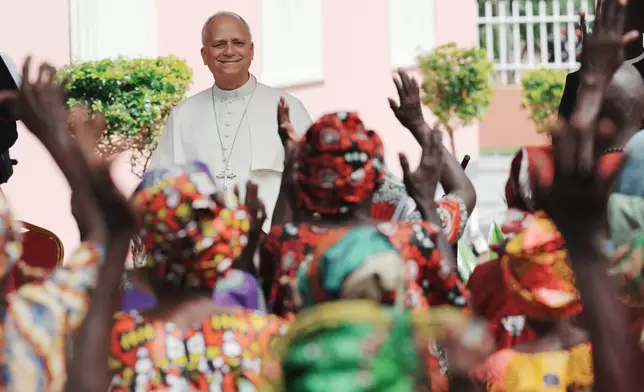 Pope Leo XIV is cheered by faithful on the occasion of his visit to a nursing home, in Saurimo, Angola, Monday, April 20, 2026. (AP Photo/Andrew Medichini)