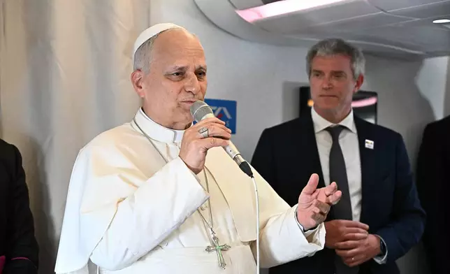 Pope Leo XIV answers journalists' questions during his flight from Yaounde, Cameroon to Luanda, Angola, Saturday, April 18, 2026. (Luca Zennaro/Pool Photo via AP)