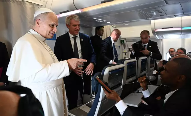 Pope Leo XIV answers journalists' questions during his flight from Yaounde, Cameroon to Luanda, Angola, Saturday, April 18 2026. (Luca Zennaro/Pool Photo via AP)