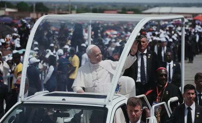 Pope Leo XIV is cheered by faithful as he arrives to celebrate a mass at Saurimo esplanade, Angola, Monday, April 20, 2026. (AP Photo/Andrew Medichini)