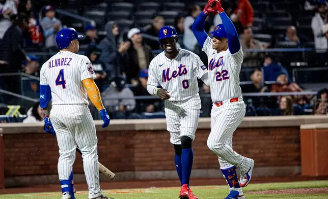 New York Mets' Ronny Mauricio (0) Juan Soto (22) celebrate scoring on Soto's two-run home run during the fourth inning of a baseball game against the Washington Nationals, Tuesday, April 28, 2026, in New York. (AP Photo/Angelina Katsanis)