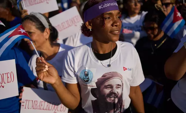 A woman attends a rally calling for the end of the U.S. blockade against the island nation in Havana, Cuba, Tuesday, April 7, 2026. (AP Photo/Ramon Espinosa)