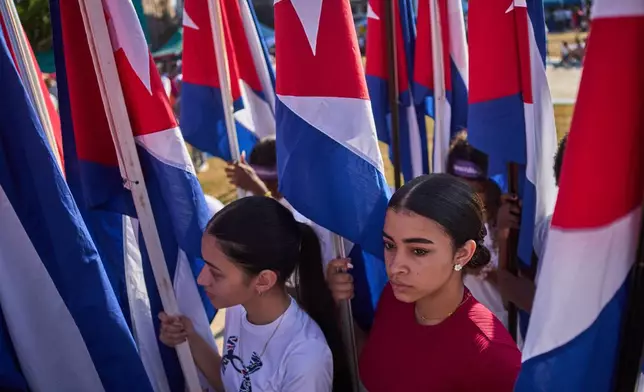 Women attend a rally calling for the end of the U.S. blockade against the island nation in Havana, Cuba, Tuesday, April 7, 2026. (AP Photo/Ramon Espinosa)