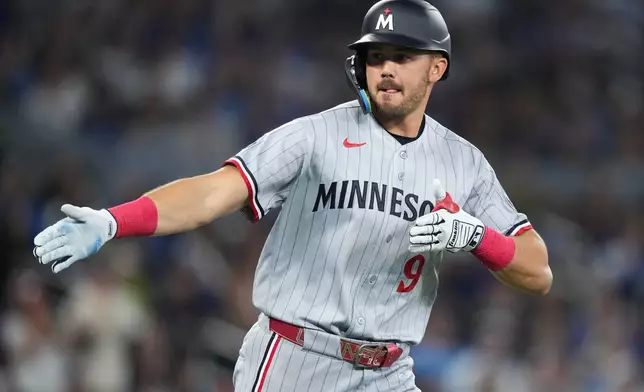 Minnesota Twins' Trevor Larnach celebrates his three-run home run during the third inning of a baseball action against the Toronto Blue Jays in Toronto, Saturday, April 11, 2026. (Nathan Denette/The Canadian Press via AP)