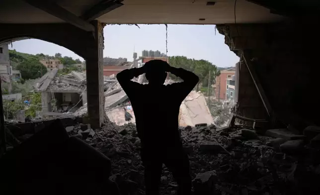 Assem Abdallah reacts as he enters his friend apartment destroyed in a Israeli airstrike in Kfar Roumman, southern Lebanon, Friday, April 17, 2026, following a ceasefire between Israel and Hezbollah. (AP Photo/Hassan Ammar)