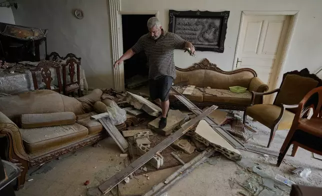 Lebanese Rida Hijazi checks his house damaged in an Israeli airstrike on Thursday, in the city of Tyre, southern Lebanon, Saturday, April 18, 2026. (AP Photo/Bilal Hussein)